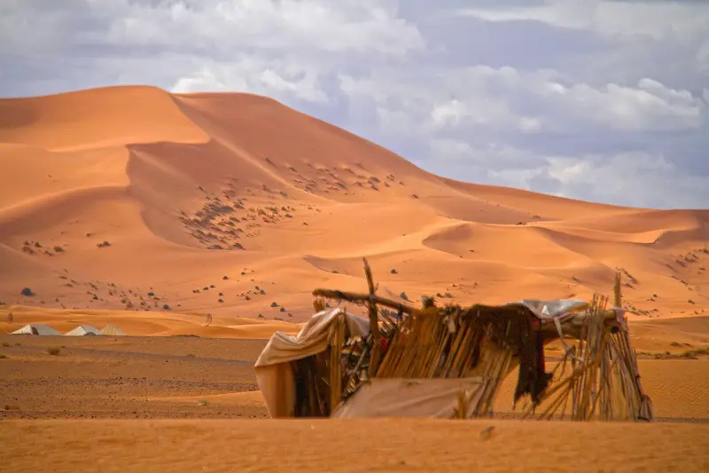 A Berber desert camp nestled among the Sahara dunes of Erg Chebbi