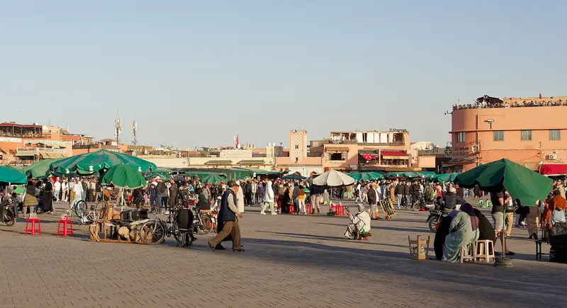 Jemaa el-Fna square in Marrakech at dusk with food stalls and crowds