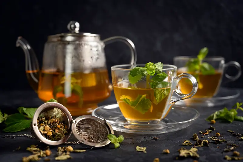 Moroccan mint tea being poured from a silver teapot